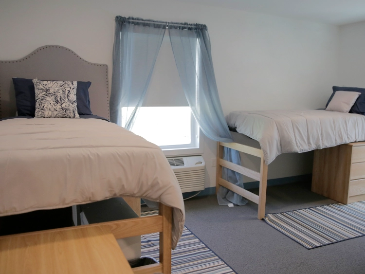 CATS Academy Boston double dorm room with two lofted beds and storage