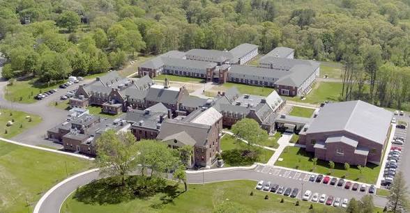 Aerial view of the campus surrounded by woodland