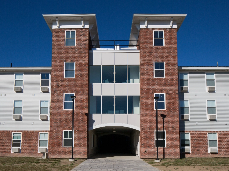 Brick residence hall with twin towers and a central archway